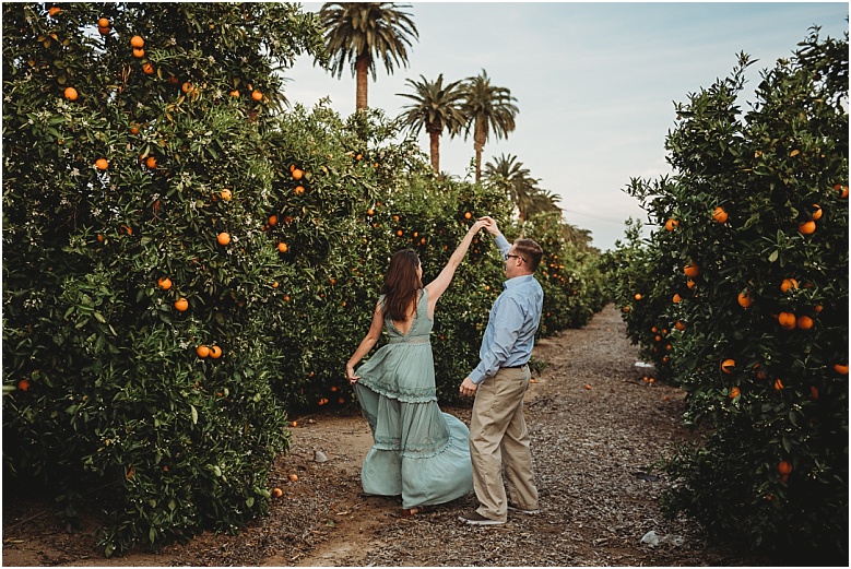 couple dancing in orange groves at California Citrus State Historic Park in Riverside, CA by Dallas Wedding Photographer for their engagement session 
