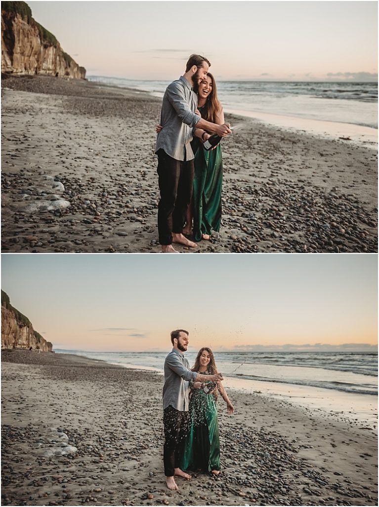 June and Christian beach engagement session in Encinitas, Ca champagne pop during beach engagement session in Encinitas, Ca
