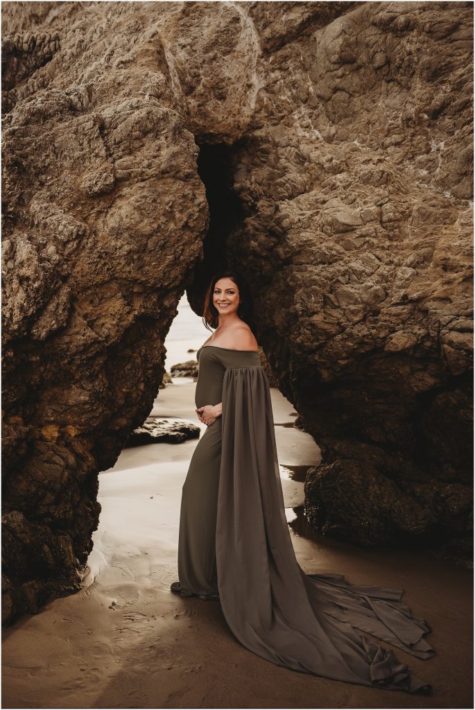Couple during maternity photos at El Matador Beach in Malibu, CA during sunset
