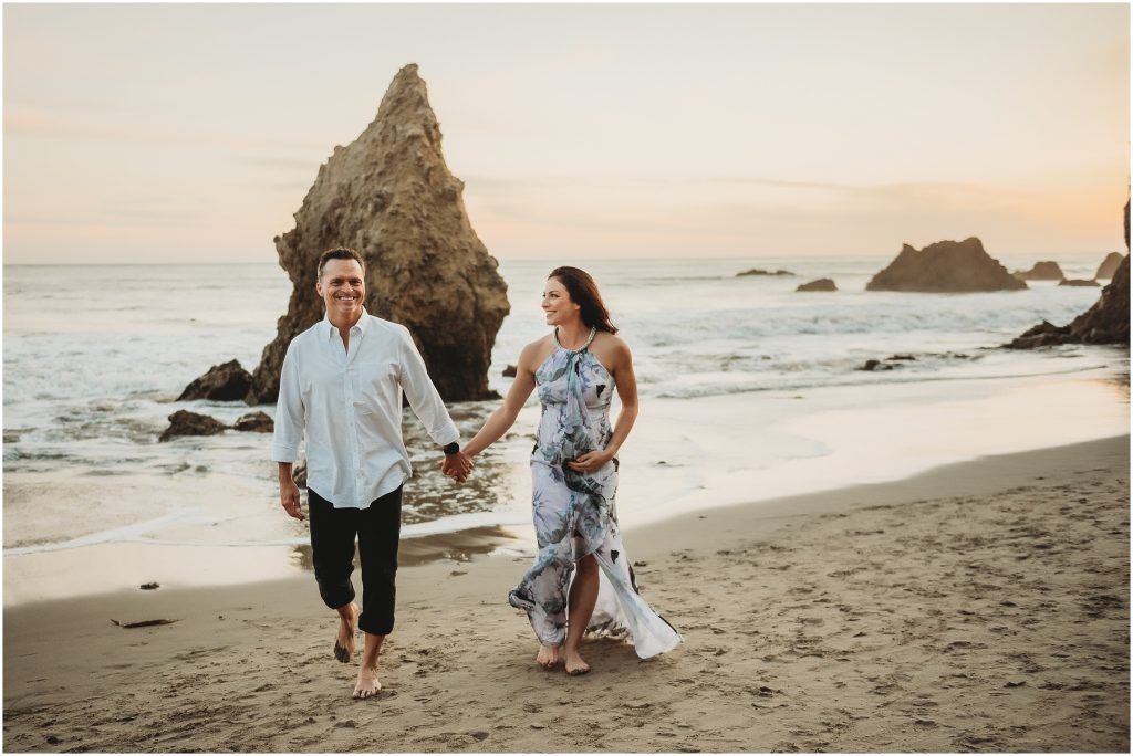 Couple during maternity photos at El Matador Beach in Malibu, CA during sunset