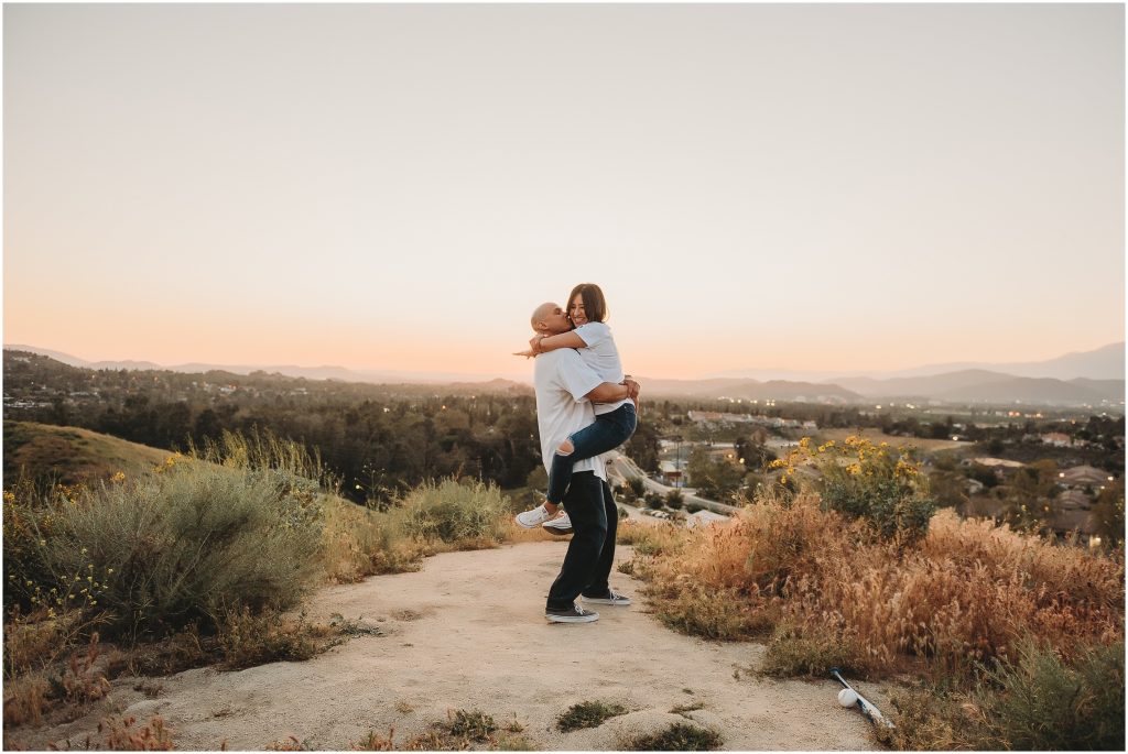Couple at sunset at Sycamore Canyon Wilderness Park in Riverside, CA wearing dodger jerseys for engagement photos