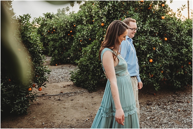 couple in orange groves at California Citrus State Historic Park in Riverside, CA by Dallas Wedding Photographer for their engagement session 