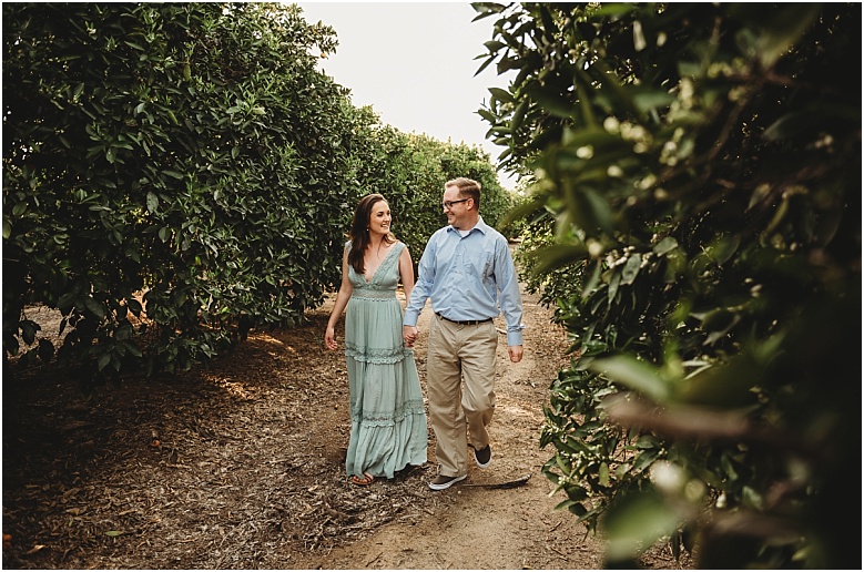 couple in orange groves at California Citrus State Historic Park in Riverside, CA by Dallas Wedding Photographer for their engagement session 