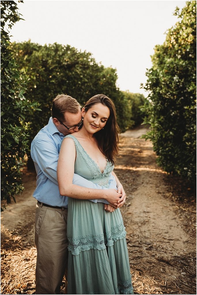 couple in orange groves at California Citrus State Historic Park in Riverside, CA by Dallas Wedding Photographer for their engagement session 