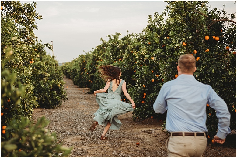 couple in orange groves at California Citrus State Historic Park in Riverside, CA by Dallas Wedding Photographer for their engagement session 