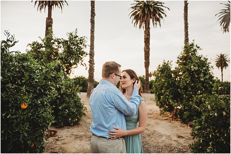 couple in orange groves at California Citrus State Historic Park in Riverside, CA by Dallas Wedding Photographer for their engagement session 