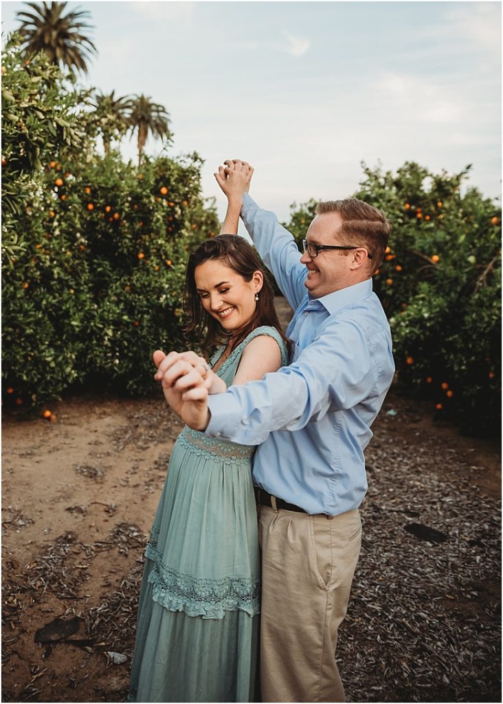 couple dancing in orange groves at California Citrus State Historic Park in Riverside, CA by Dallas Wedding Photographer for their engagement session 