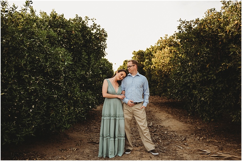 couple in orange groves at California Citrus State Historic Park in Riverside, CA by Dallas Wedding Photographer for their engagement session