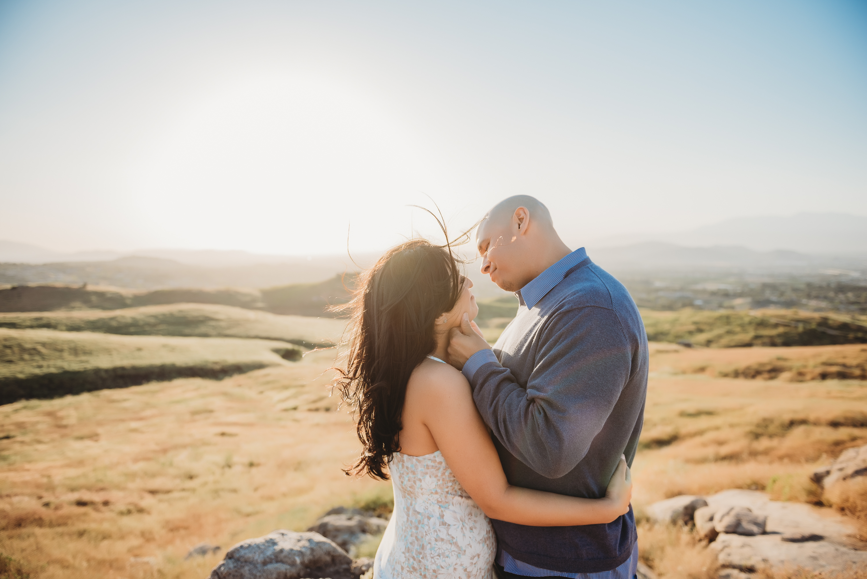 couple during windy engagement session in Riverside, CA at Sycamore Canyon Wilderness Park